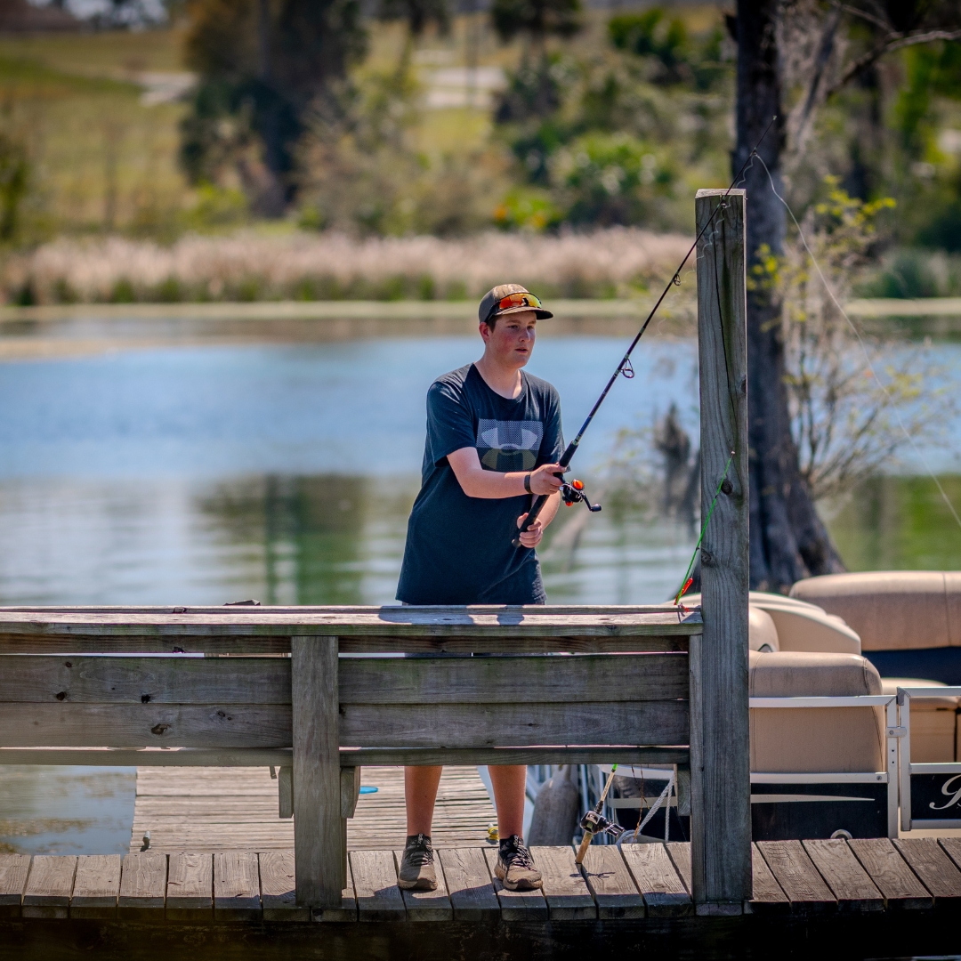 Teenage boy fishing off one of the docks at the Resort